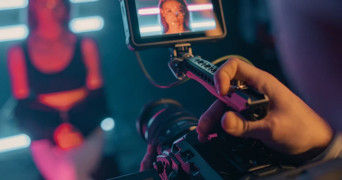 A camera rig and monitor filming a person in a studio