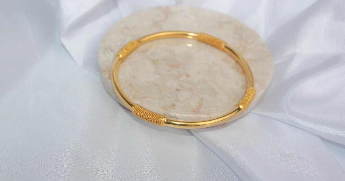 Gold jewelry photographed on light fabric