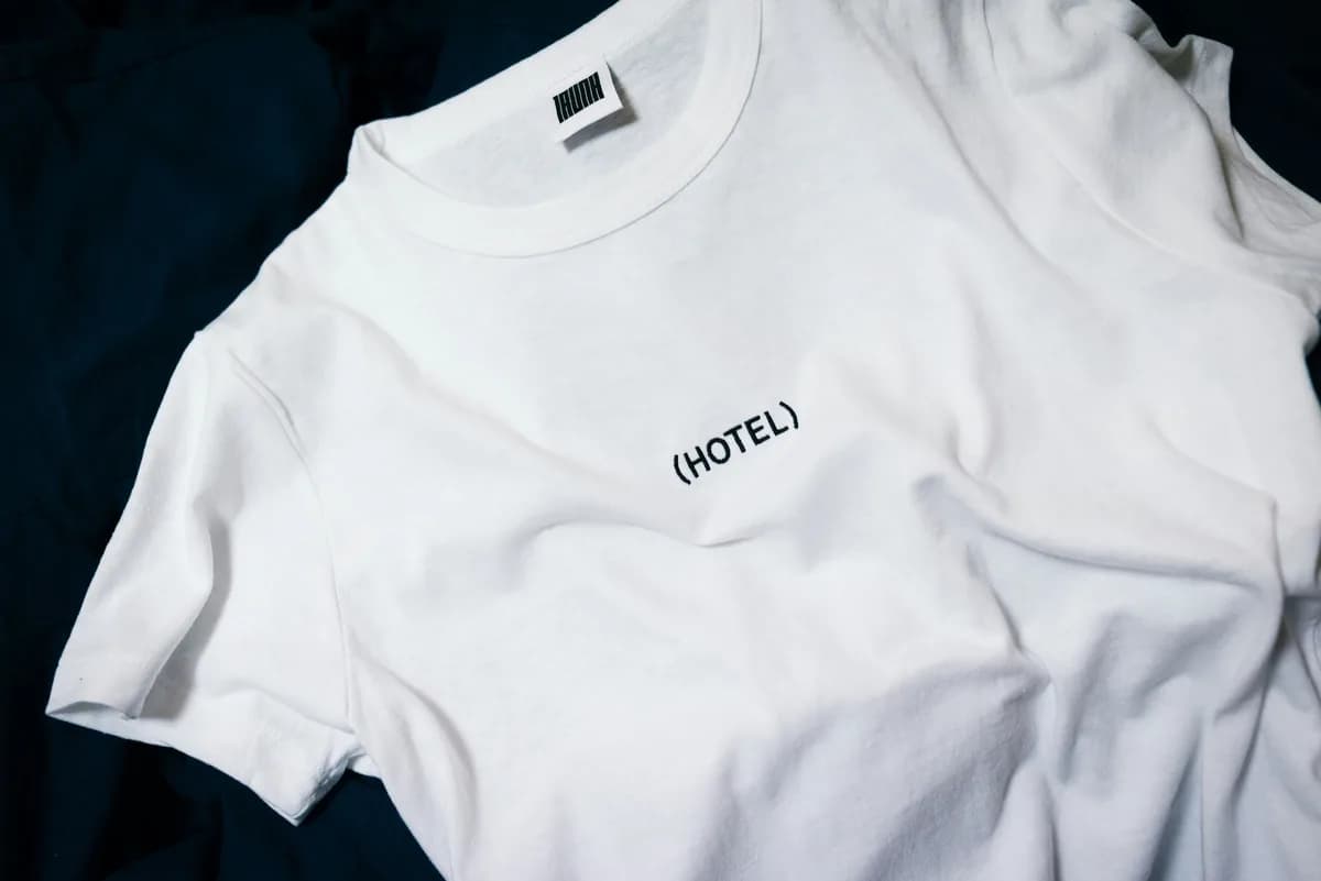White graphic tee lying on dark fabric